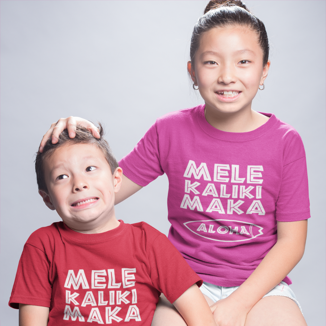 Kids Mele Kalikimaka Christmas T-Shirt with a surfboard hibiscus graphic perfect for holiday celebrations. Holiday Gift Idea! 